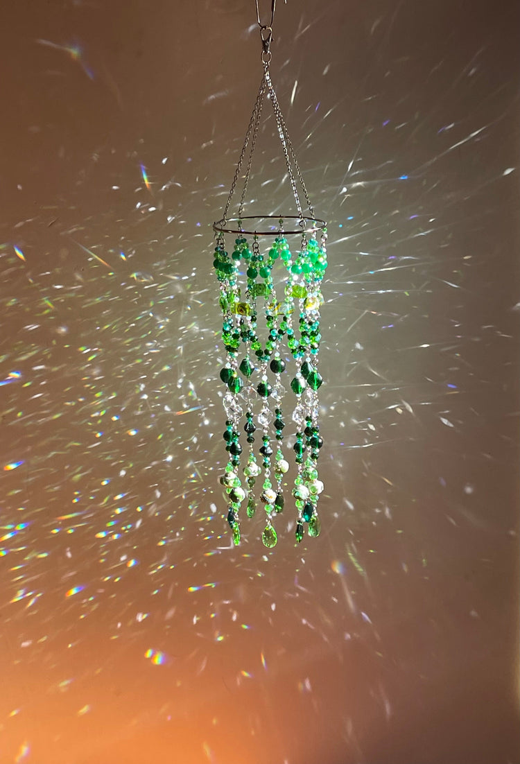 green crystal prism mobile casting rainbows and colored light
