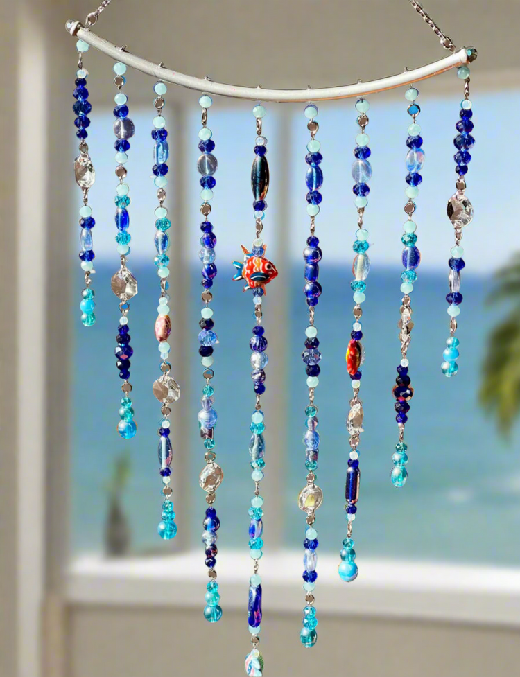 Handmade clear crystal sun catcher hanging in window creating rainbow light reflections - I and K Created