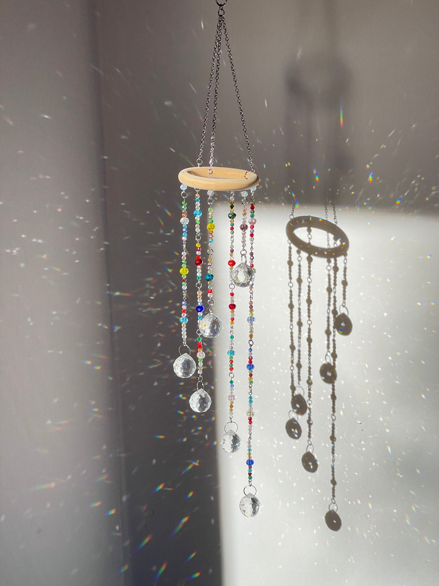Crystal sun catcher hanging creating rainbow light reflections in room